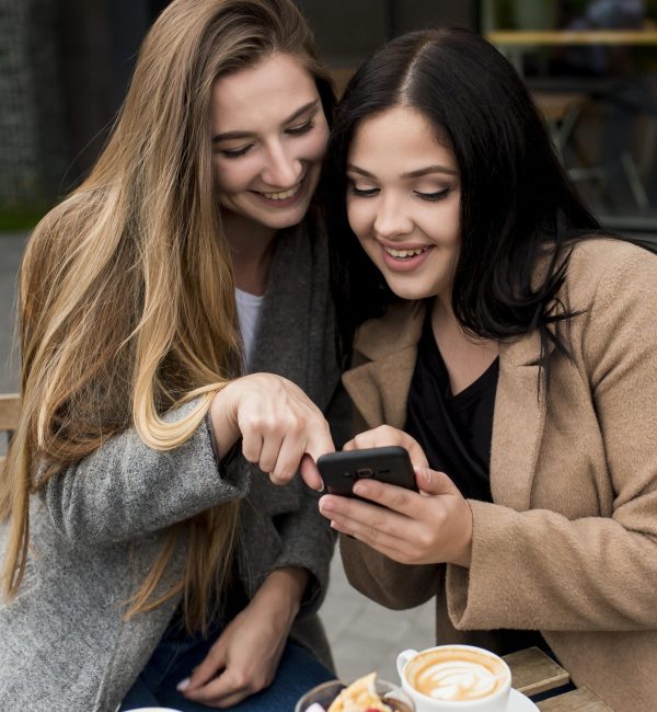 woman-showing-something-her-phone-her-friend